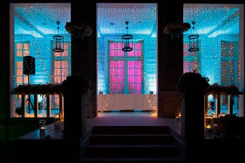 Warm lighting across the front of a house for a wedding